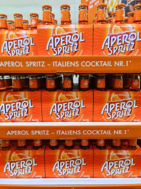 Kiel, Almanya - 09. Ağustos 2025: Süpermarket rafına istiflenmiş turuncu Aperol Spritz şişeleri ve kutular satın alınmaya hazır