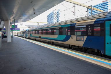Viyana, Avusturya - 10. Temmuz 2025: Modern şehir istasyonunda uzun elektrikli yolcu treni kalkışa hazır.