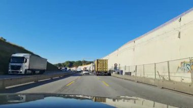 Hamburg, Germany - 25. September 2025: Driver's point of view driving slowly in a massive traffic jam with a long line of trucks