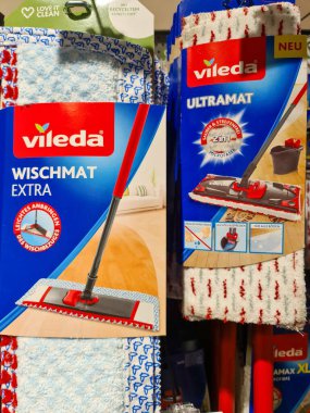 Different Vileda mops and refills displayed on a supermarket shelf for household cleaning