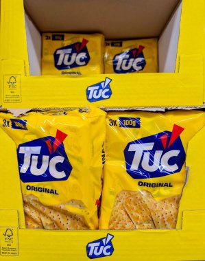 TUC Original crackers multipacks displayed in yellow cardboard packaging inside a supermarket