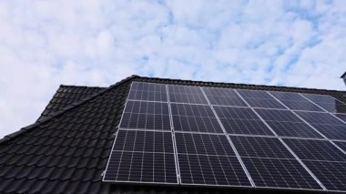 Modern solar panels installed on a residential house rooftop. Clean, renewable energy system converting sunlight into sustainable electricity