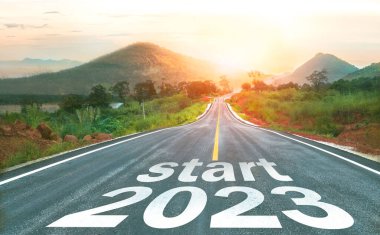 2023 'ü gün batımında asfalt yolun ortasındaki otoyolda yazmaya başla. 2022-2023 için planlama ve meydan okuma kavramı, iş stratejisi, fırsat, umut, yeni bir hayat değişimi..
