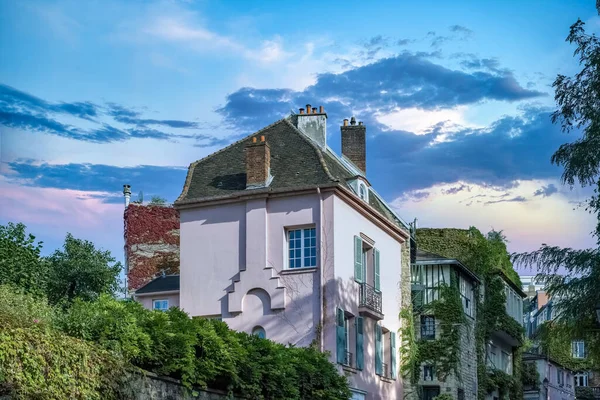 Paris, France, famous pink house in Montmartre, in a typical street