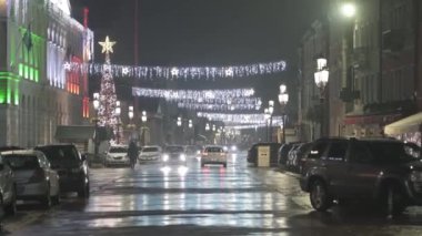 Chioggia, December 2022. Wet road with cars at night with Christmas illuminations