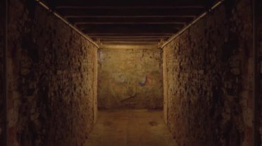 Dark tunnel with brick walls and wooden ceiling