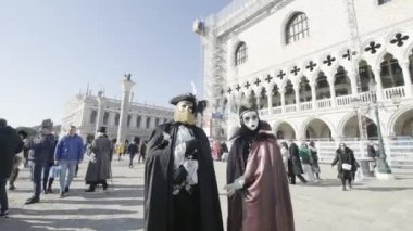 Venice, Italy - February 2023. Dressed for the Carnival of Venice, they pose in the square