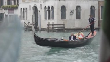 Venice, Italy - February 2023 - Gondolier takes tourists on the gondola on the Grand Canal