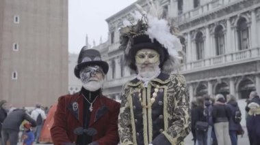 Venice, Italy - February 2023 - Two medieval men pose in front of St. Marks Basilica