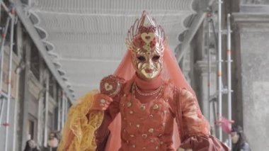 Venice, Italy - February 2023 - Woman with a beautiful mask under the Venetian arcades