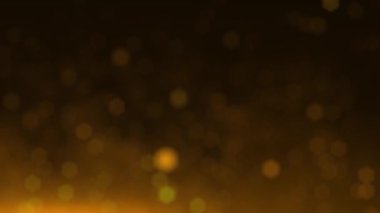 Bokeh 'in bulanık altın parçacıkları siyah arkaplanda uçuyor