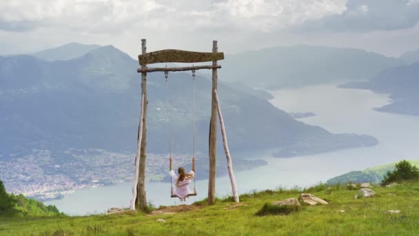 Woman White Dress Swings Wooden Swing Placed Mountain Lake Como — Stock Video