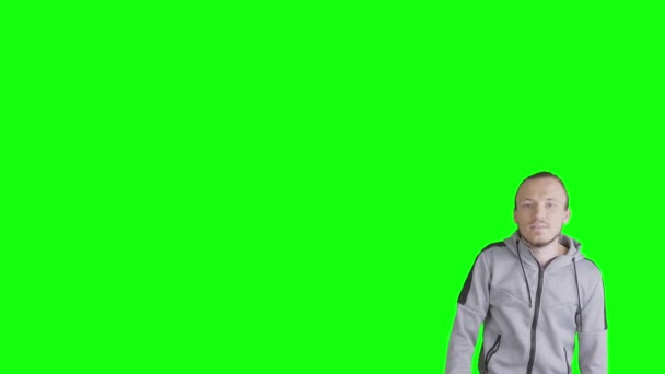 Man Appears Green Background Points His Finger Empty Cpy Space — Stock Video