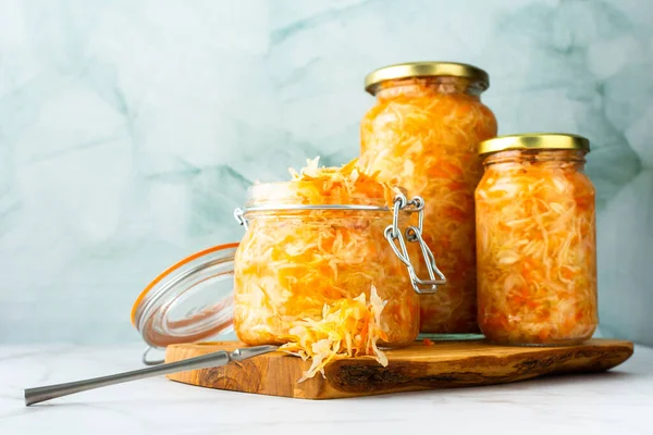 Fresh fermented vegetables, fermented cabbage with carrots in glass jars, healthy natural probiotics, healthy food, sauerkraut