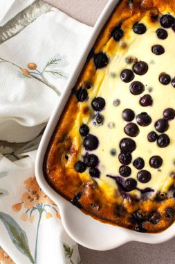 Delicious sweet cheesecake with blueberries in an oval dish, top view