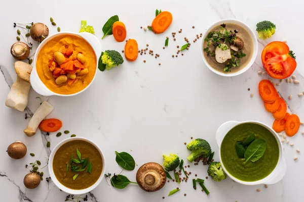 stock image Mushroom and lentil cream soup, phaloli, carrot and tomato soup, broccoli and spinach soup on white background with cooking ingredients, copy space