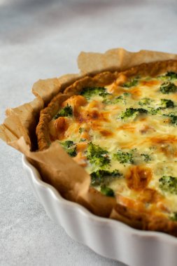 Homemade pie with red fish and broccoli, quiche with salmon and char, cheese and cream