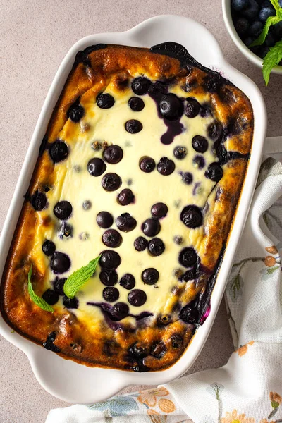 Delicious sweet cheesecake with blueberries in an oval dish, top view