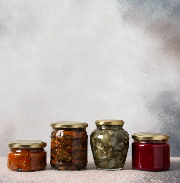 stock image Preserving vegetables for the winter, canned vegetables in jars on a light background, pickled or fermented vegetables, copy space