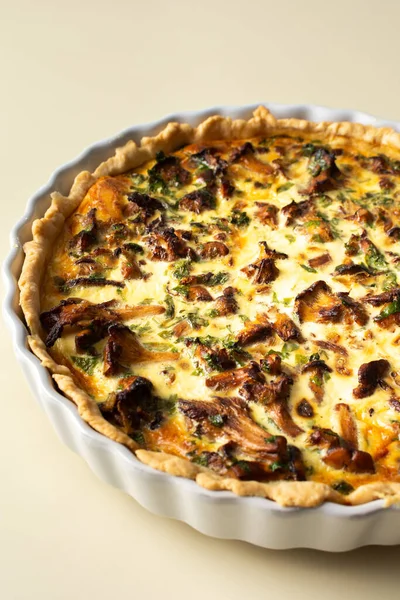 stock image Homemade quiche with seasonal forest mushrooms Chanterelles in a round shape on a yellow background