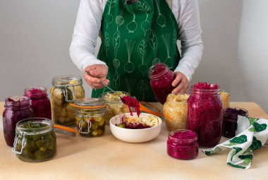 Fermenting different cabbages, white and red cabbage, Brussels and cauliflower, broccoli, woman fermenting sauerkraut clipart