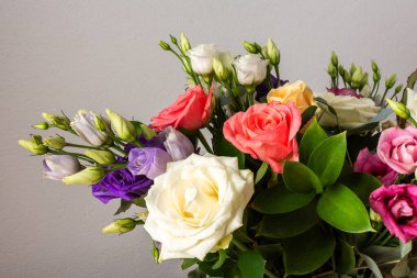 Taze güller ve okaliptüs içeren renkli bir yaz buketi ile özel kutlamalar, güzel ve güzel kokulu bir çiçek aranjmanı oluşturur.