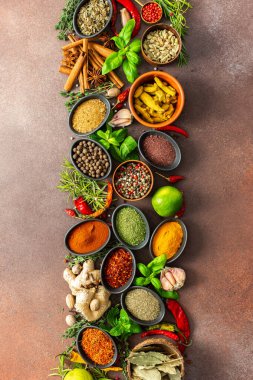 An artistic display of fragrant herbs and spices, scattered on a brown surface, blending natural hues textures for a rustic culinary charm clipart