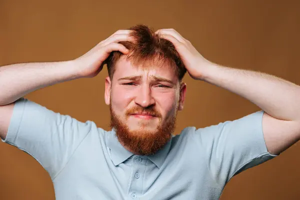 This young adults facial expression is truly remarkable in this studio shot, with an amazed look that will leave you captivated. teenage guys expressive face is captured perfectly in this studio