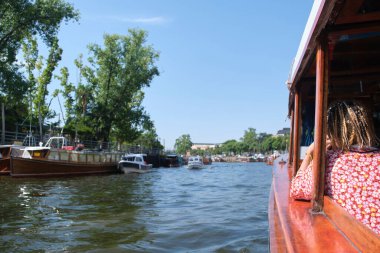 Tourist boat trip through the Tigre delta on a summer afternoon, view from inside the ship. Common tourist attraction as a weekend getaway in Buenos Aires, Argentina. Composition with copy space.