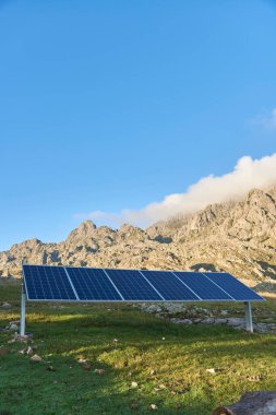 Sürdürülebilirlik: fotovoltaik hücreler, güneş panelleri, Los Gigantes, Cordoba, Arjantin 'in doğal kırsal kesiminde elektrik üretimi için, dağlık vahşi bir manzara. Kopyalama alanı olan resim.