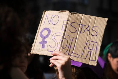 Buenos Aires, Arjantin; 8 Mart 2024: Uluslararası feminist grev. Kadın sembolü ve metni olan bir afişi kaldırırken yalnız değilsin..