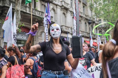 Buenos Aires, Arjantin; 8 Mart 2024: Uluslararası feminist grev sırasında Arjantin ulusal hükümetini protesto eden ve maske takan bir kadın.