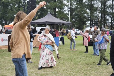 25 Mayıs 2025; Lobos, Buenos Aires, Arjantin: Ulusal bayramda geleneksel yemek, el sanatları ve müzikle yapılan bir kutlama olan Fiesta de la empanada sırasında halk müziği dansı yapan insanlar