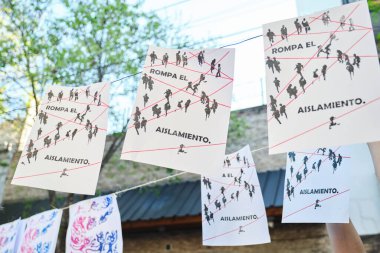 Buenos Aires, Argentina; October 4, 2025: Screen-printed posters during the Flores book fair, with the event slogan: Break the isolation.