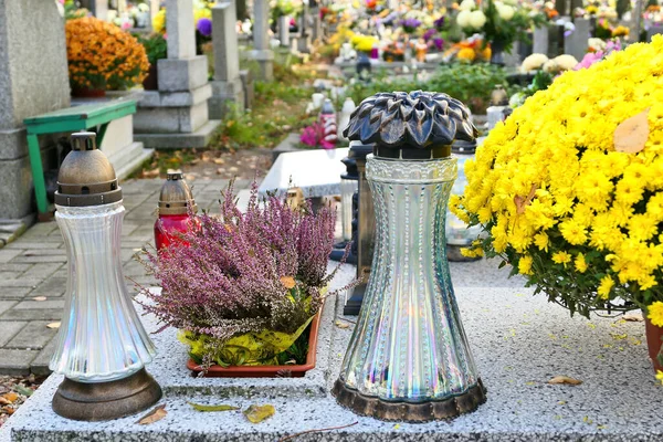 All the Saints Day holiday on 1 November in Poland. Flowers and candles on the grave at cemetery.