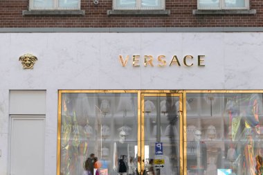Amsterdam, Netherlands - May 1, 2022 : Versace boutique in Amsterdam town. Versace is an Italian luxury fashion brand. clipart