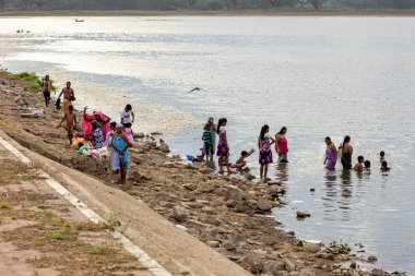 People are bathing at a river in tissamaharama Sri Lanka, July 15, 2017 clipart