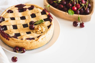 Tasty American cherry pie on white background. Top view. Copy space