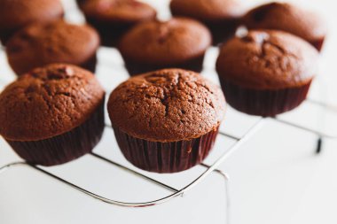 Homemade baked cherry muffins with fresh berries on white wooden table