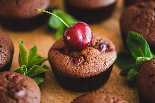 stock image Homemade baked cherry muffins with fresh berries on wooden table