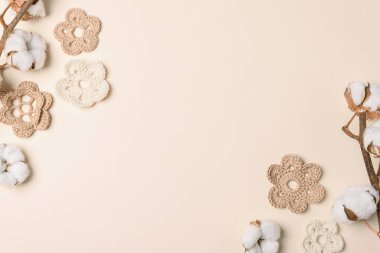 Yumuşak bej arka planda el yapımı yumurta, örgü ve pamuk çiçekleri. Üst Manzara. Boşluğu kopyala