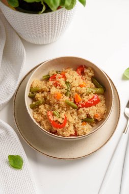 Beyaz ahşap masada kinoa sebze salatası. Vejetaryen ve diyet yemekleri