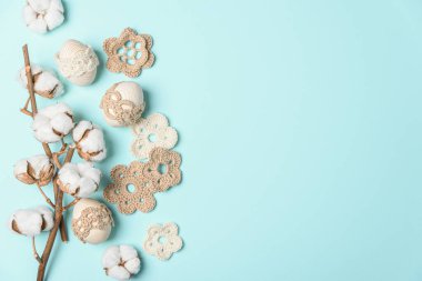 El yapımı yumurta, örgü ve mavi arka planda pamuk çiçekleri. Üst Manzara. Boşluğu kopyala