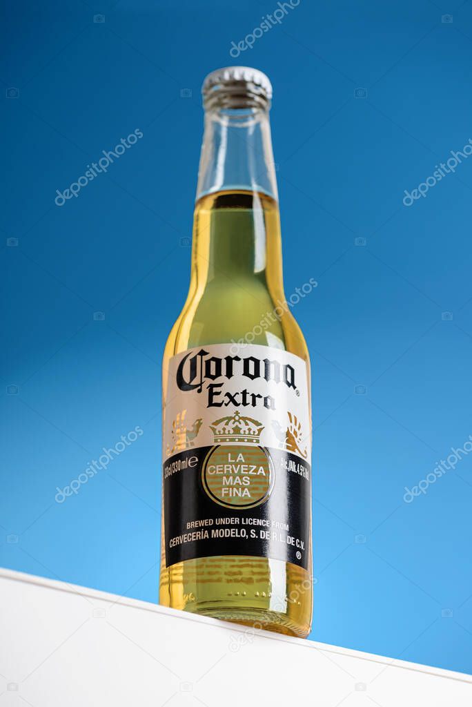 Lviv, Ukraine - April 22, 2025: Mexican Corona Extra beer glass bottle on podium
