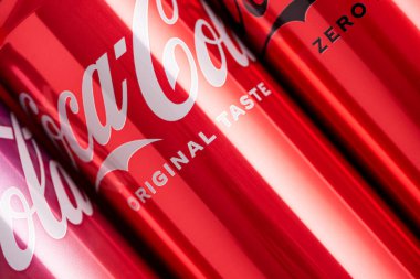 Lviv, Ukrayna - 05 Mayıs 2025: Coca Cola 'nın demir kutuları: klasik, sıfır şeker, sıfır şeker sıfır kafein, kırmızı arka planda kiraz aroması. Üst görünüm