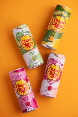 Lviv, Ukrayna - 6 Mayıs 2025: Demir içki kutuları Chupa Chups: sarı arka planda çilek, kavun, mango ve ahududu aroması. Üst görünüm