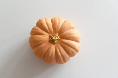 Beyaz ahşap masada turuncu balkabağı. Üst görünüm