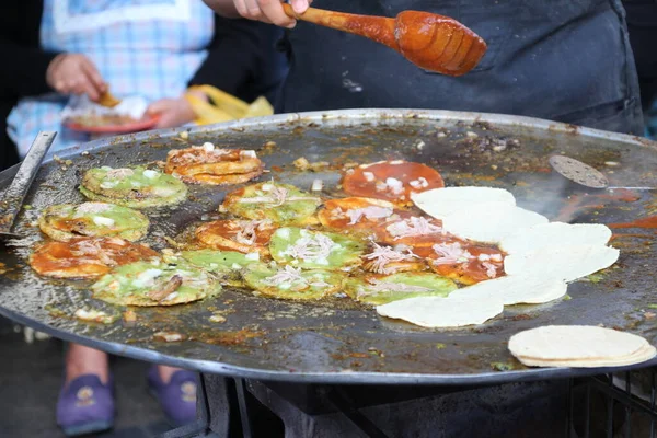 the traditional chalupas, fried tortillas with sauce and some meat stew in the streets of Puebla