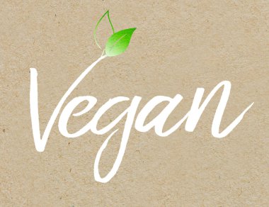 Kahverengi geri dönüştürülmüş kağıt arka planda beyaz renkli harf vegan
