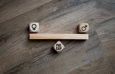 Cubes, dice or blocks with gender pay gap on wooden background clipart